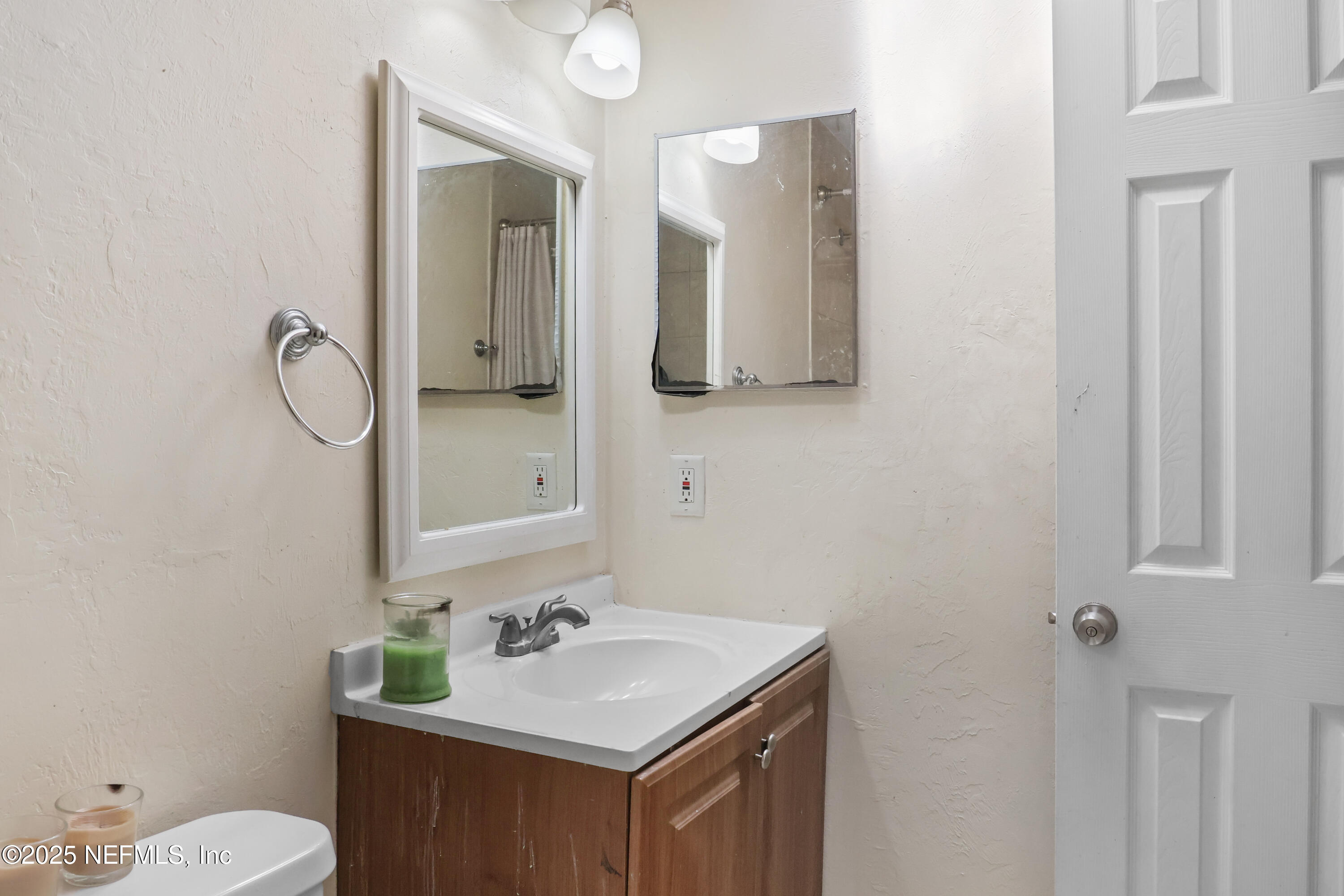 713 Southwest 69th Street, Unit A & B Gainesville, FL 32607 - Photo 19 of 21 a bathroom with a sink vanity mirror and toilet
