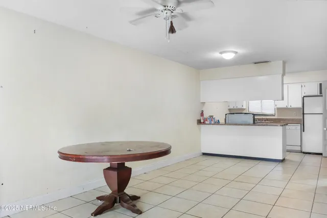 a living room with a couch and a chandelier fan
