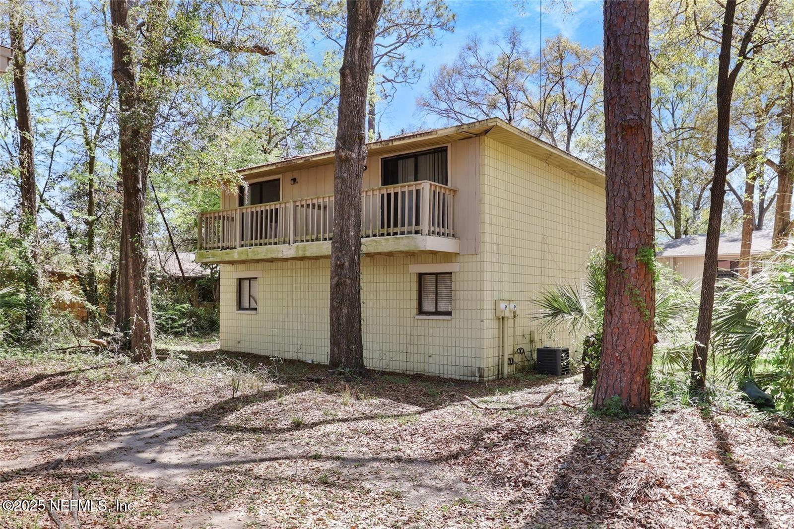 713 Southwest 69th Street, Unit A & B Gainesville, FL 32607 - Photo 21 of 21 a view of a house with a backyard