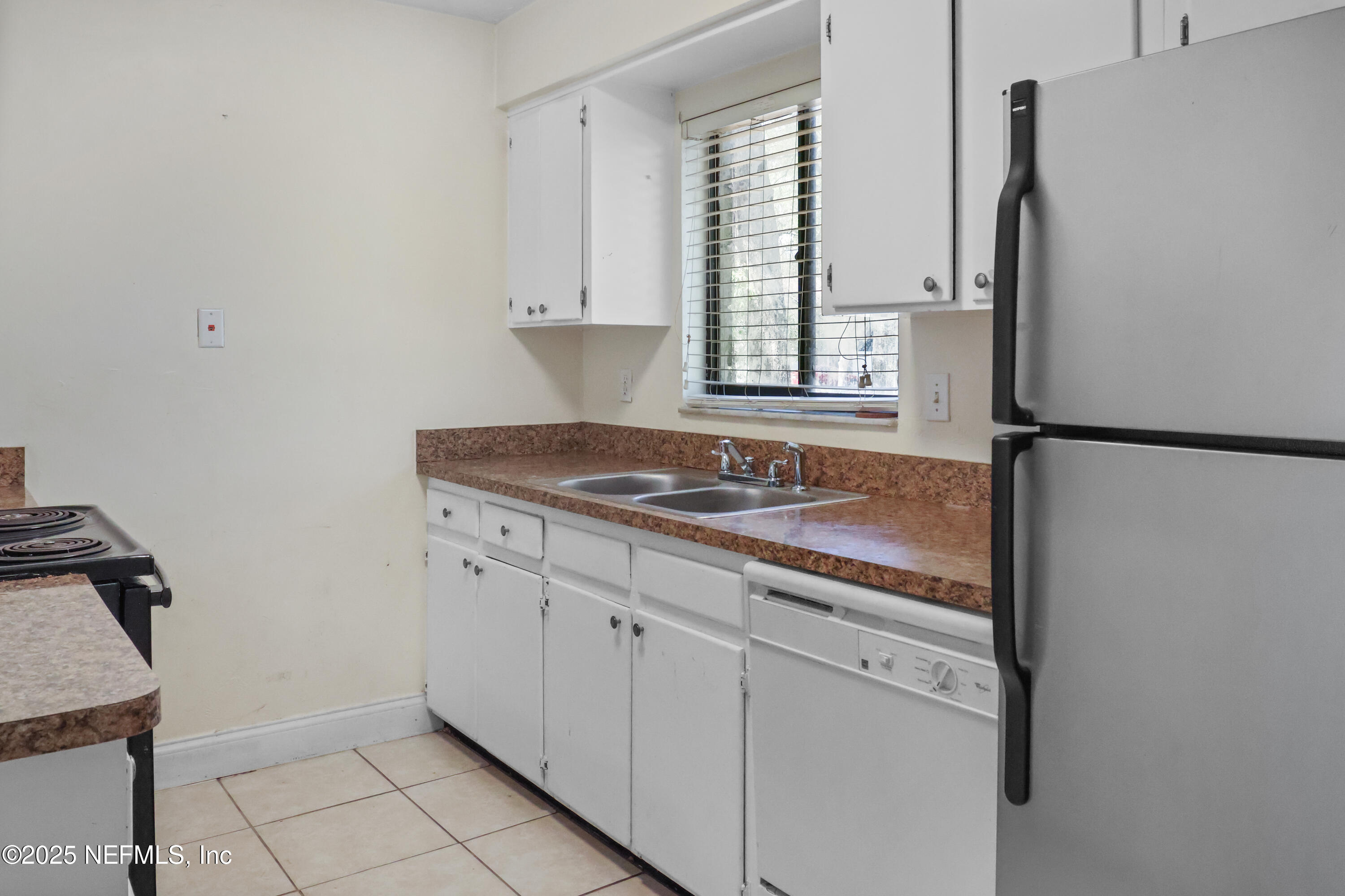 713 Southwest 69th Street, Unit A & B Gainesville, FL 32607 - Photo 3 of 21 a kitchen with stainless steel appliances granite countertop a sink stove and refrigerator