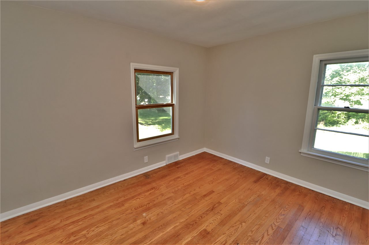 4330 Hononegah Road Roscoe, IL 61073 - Photo 11 of 25 an empty room with wooden floor and windows