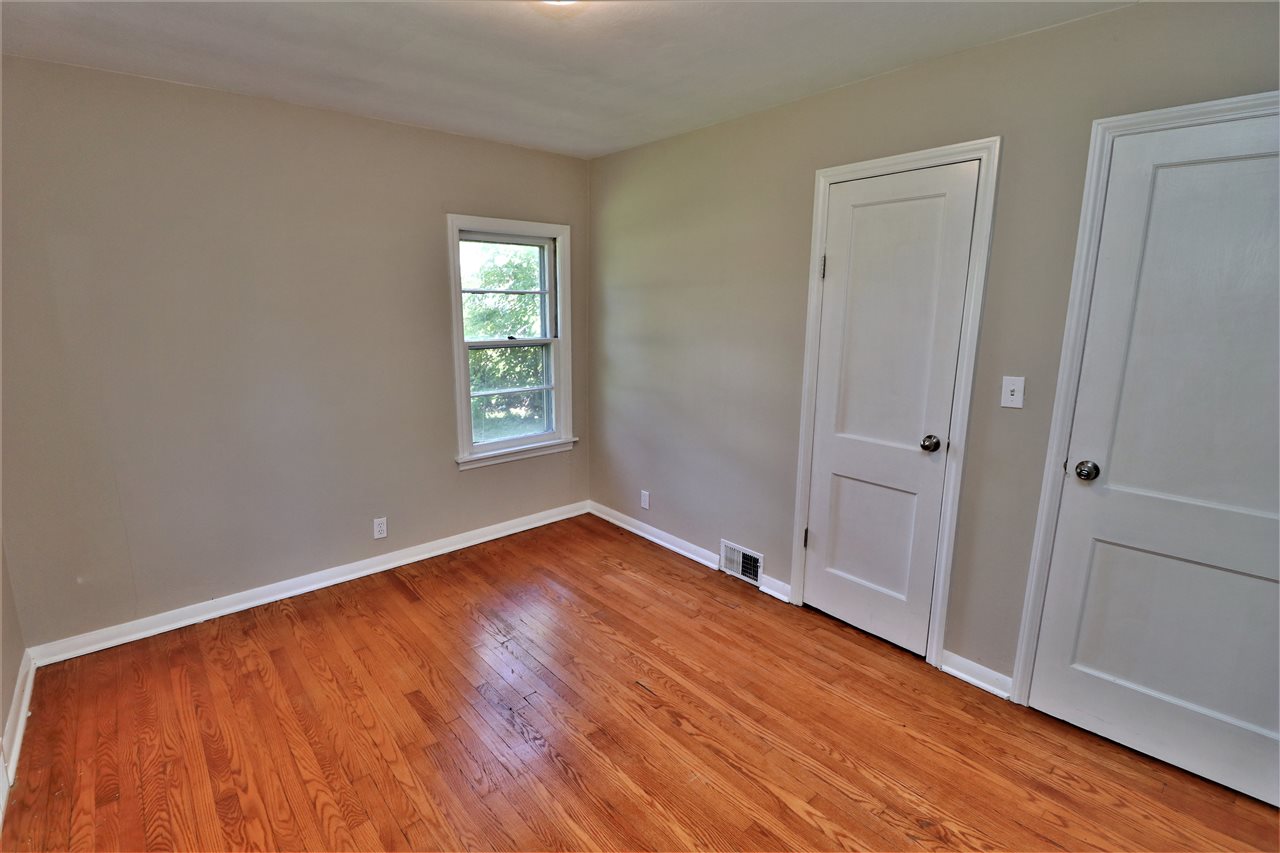 4330 Hononegah Road Roscoe, IL 61073 - Photo 12 of 25 an empty room with wooden floor and windows