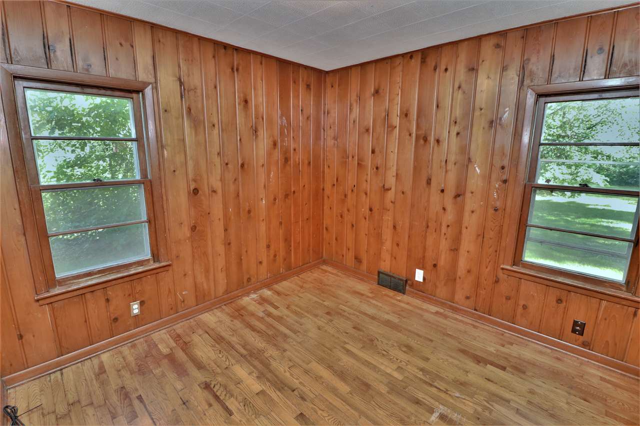 4330 Hononegah Road Roscoe, IL 61073 - Photo 13 of 25 a view of a room with a window and a bathroom with wooden floor