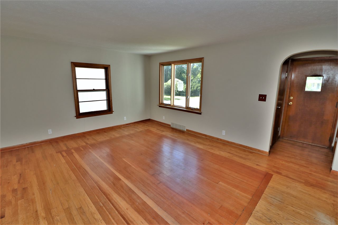 4330 Hononegah Road Roscoe, IL 61073 - Photo 3 of 25 an empty room with wooden floor and windows
