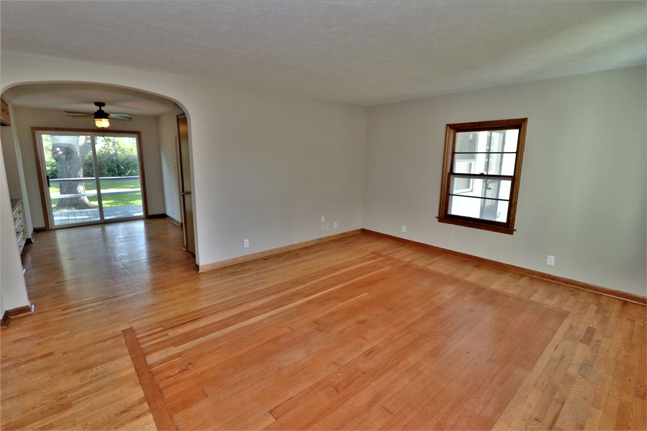 4330 Hononegah Road Roscoe, IL 61073 - Photo 4 of 25 an empty room with wooden floor and windows