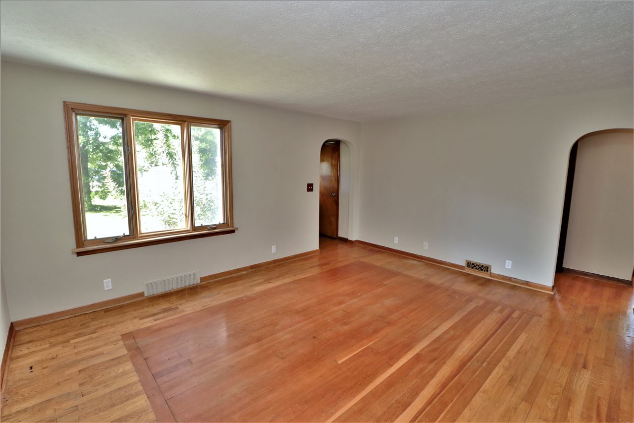 4330 Hononegah Road Roscoe, IL 61073 - Photo 5 of 25 an empty room with wooden floor and windows