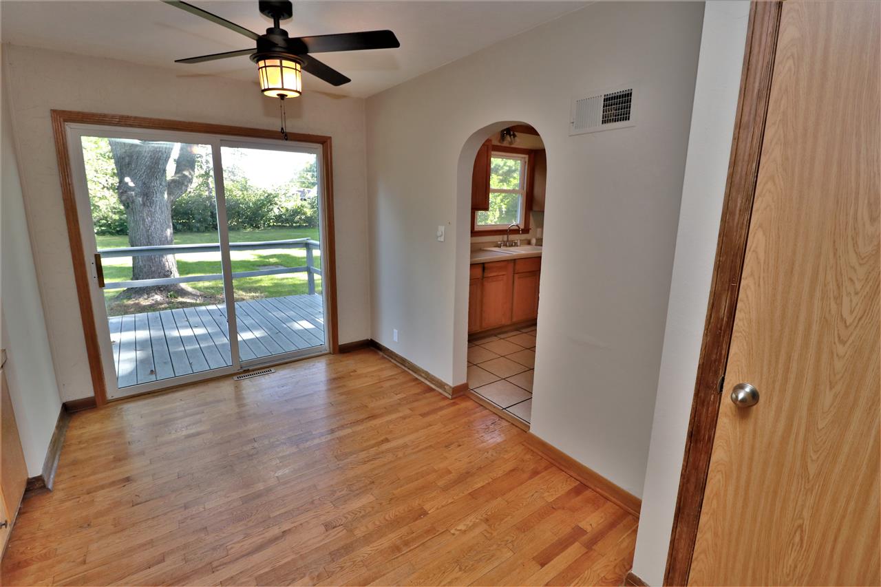 4330 Hononegah Road Roscoe, IL 61073 - Photo 7 of 25 an empty room with wooden floor fan and windows