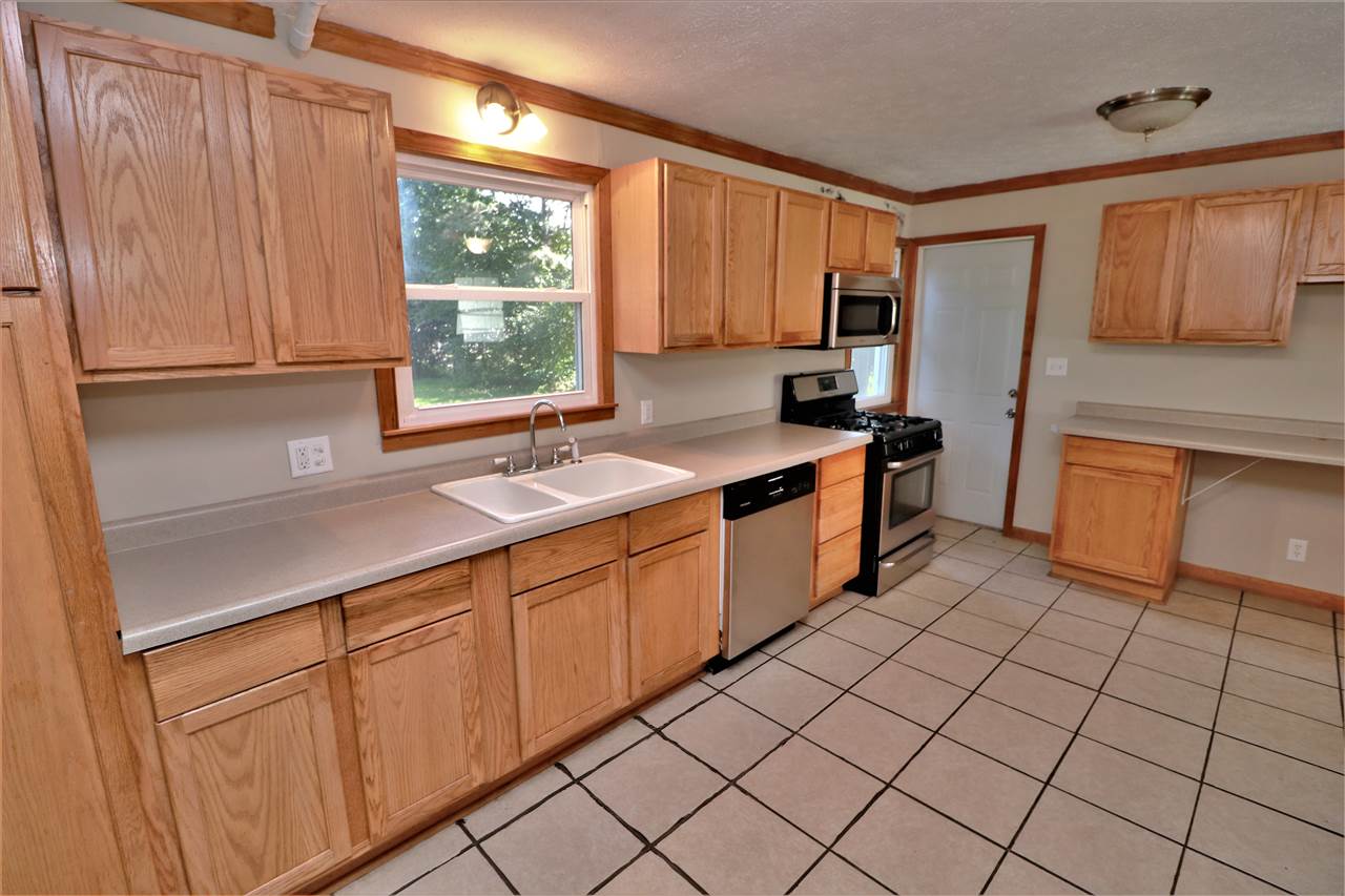 4330 Hononegah Road Roscoe, IL 61073 - Photo 9 of 25 a kitchen with stainless steel appliances granite countertop a sink stove and refrigerator
