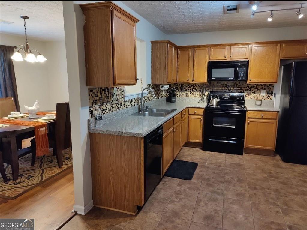 1600 Keystone Drive Conley, GA 30288 - Photo 4 of 12 a kitchen with stainless steel appliances granite countertop a stove a sink and a microwave
