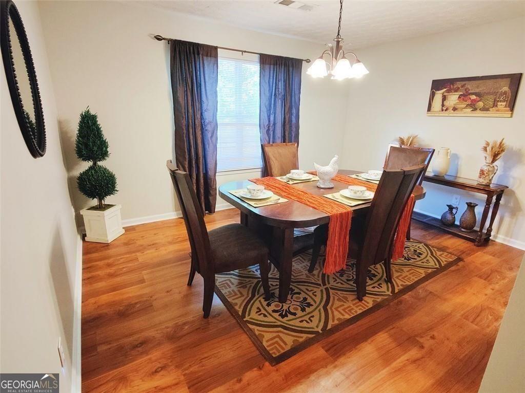 1600 Keystone Drive Conley, GA 30288 - Photo 5 of 12 a view of a dining room with furniture and wooden floor