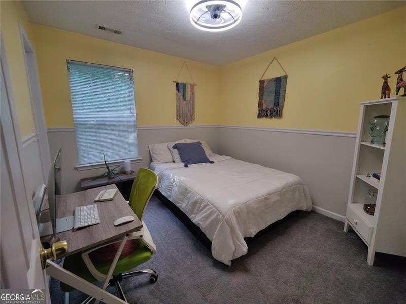 1600 Keystone Drive Conley, GA 30288 - Photo 8 of 12 a bedroom with a bed and a desk
