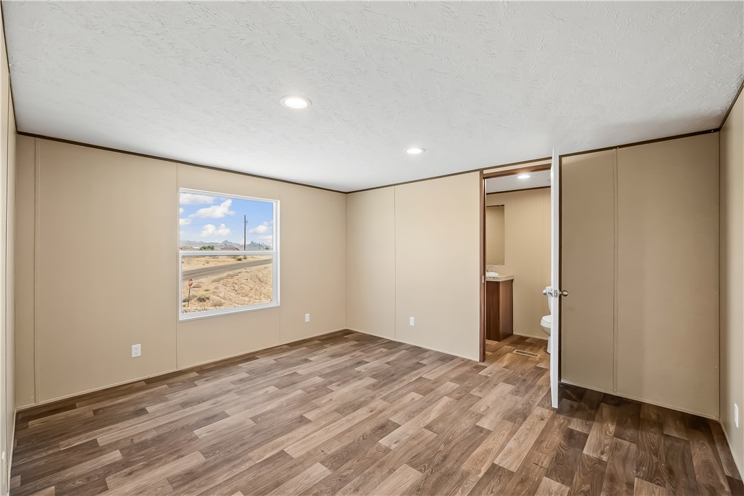 13205 South Water Reed Way Topock, AZ 86436 - Photo 21 of 37 an empty room with wooden floor and window