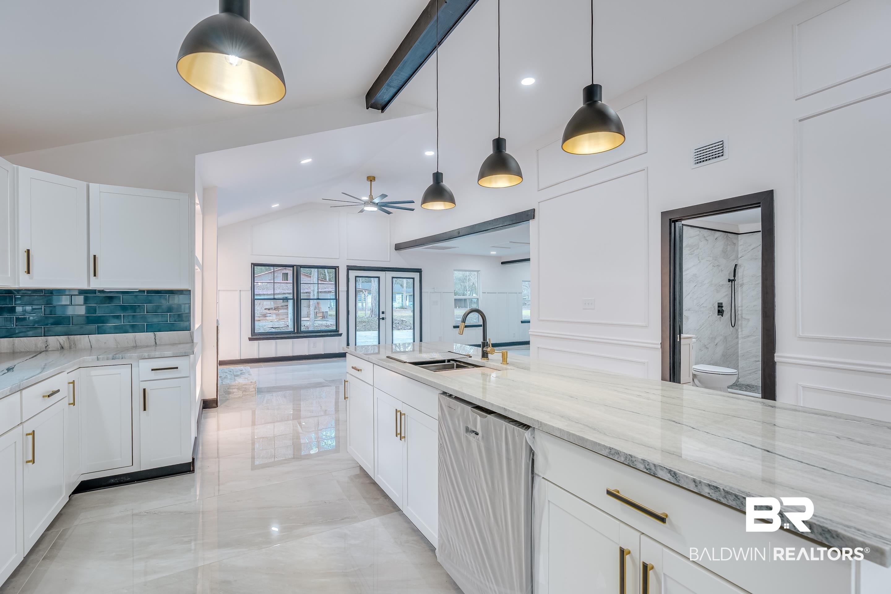 1190 Military Road Mount Vernon, AL 36560 - Photo 10 of 47 Kitchen with lofted ceiling, white cabinets, dishwasher, light stone countertops, and tasteful backsplash