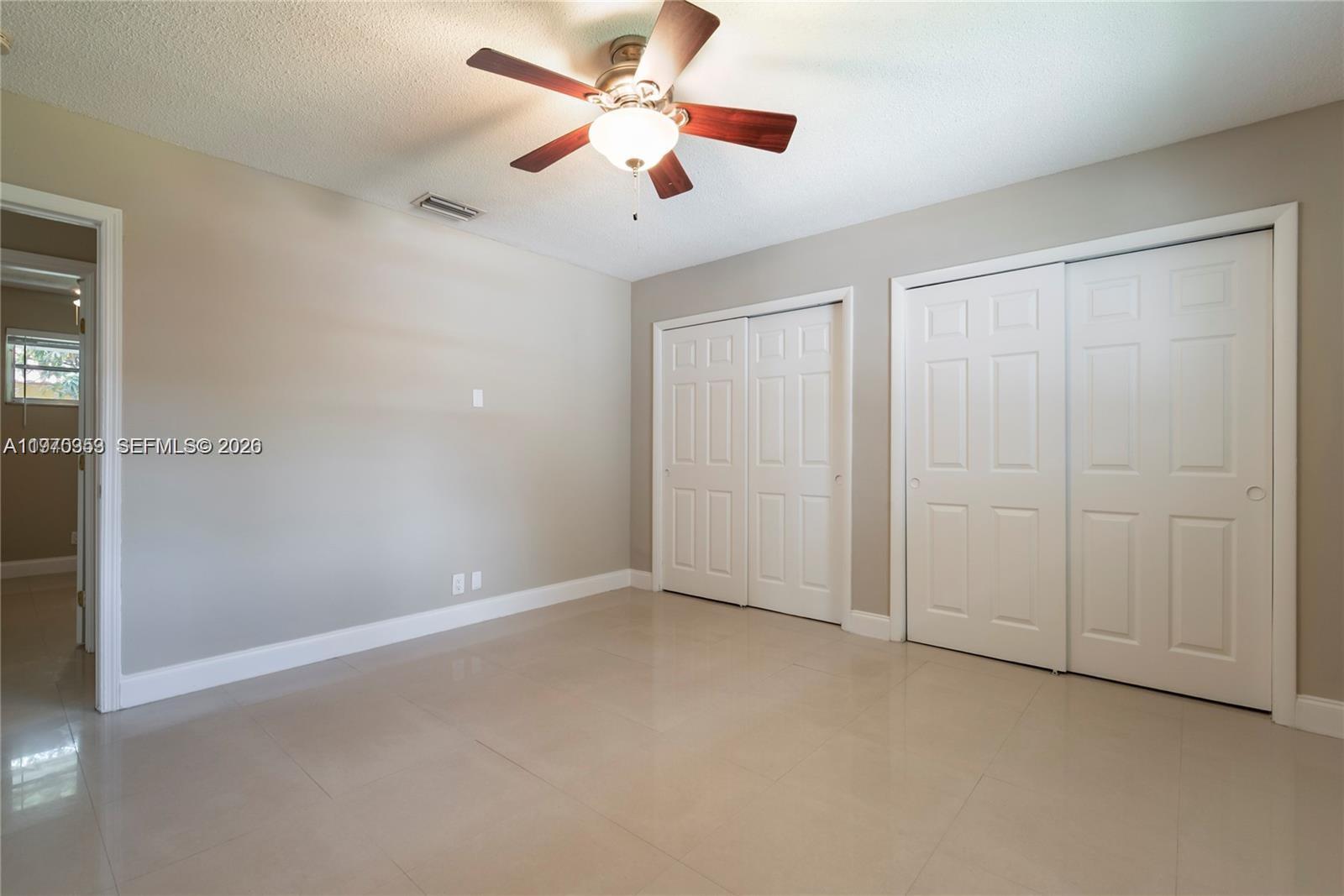 5632 Hayes Street Hollywood, FL 33021 - Photo 13 of 42 an empty room with closet and fan