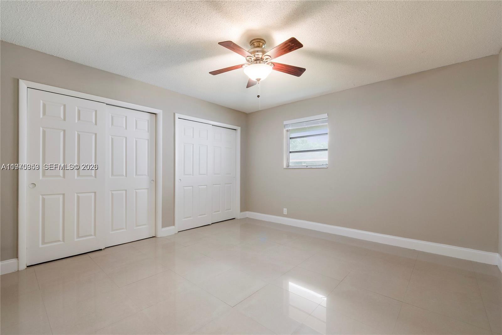 5632 Hayes Street Hollywood, FL 33021 - Photo 14 of 42 an empty room with windows and fan