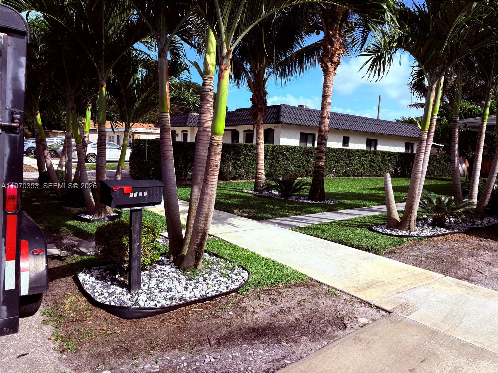 5632 Hayes Street Hollywood, FL 33021 - Photo 19 of 42 a front view of a house with garden and trees