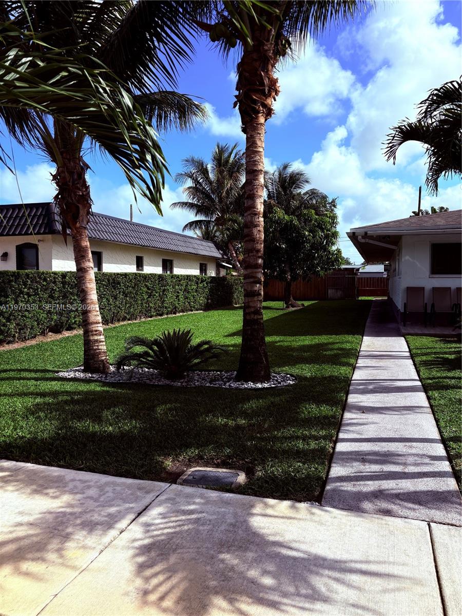 5632 Hayes Street Hollywood, FL 33021 - Photo 22 of 42 a front view of a house with a yard