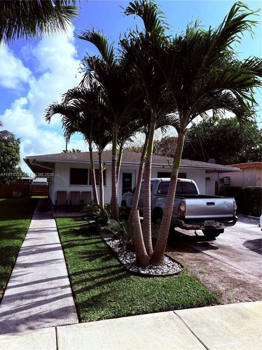 5632 Hayes Street Hollywood, FL 33021 - Photo 24 of 42 a front view of a house with garden