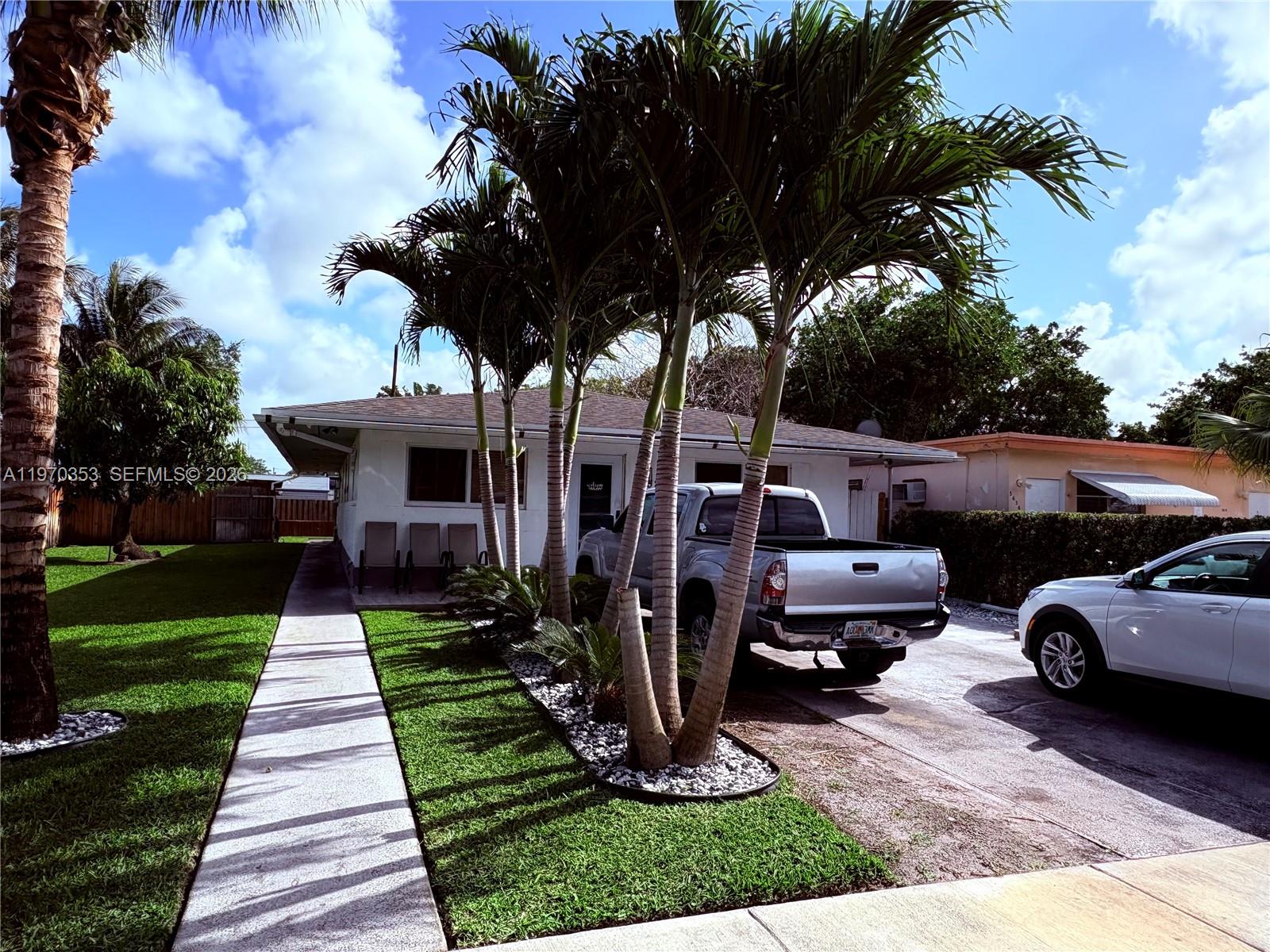 5632 Hayes Street Hollywood, FL 33021 - Photo 25 of 42 a front view of a house with garden