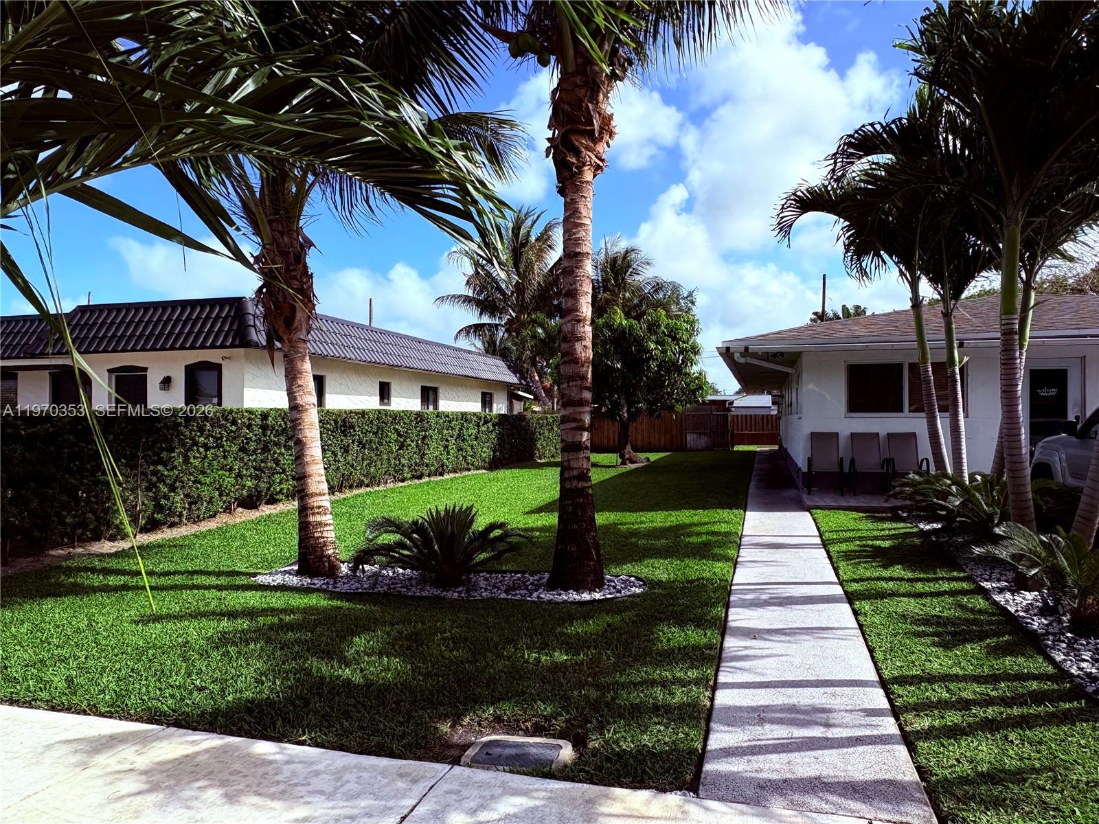 5632 Hayes Street Hollywood, FL 33021 - Photo 26 of 42 a front view of a house with a yard