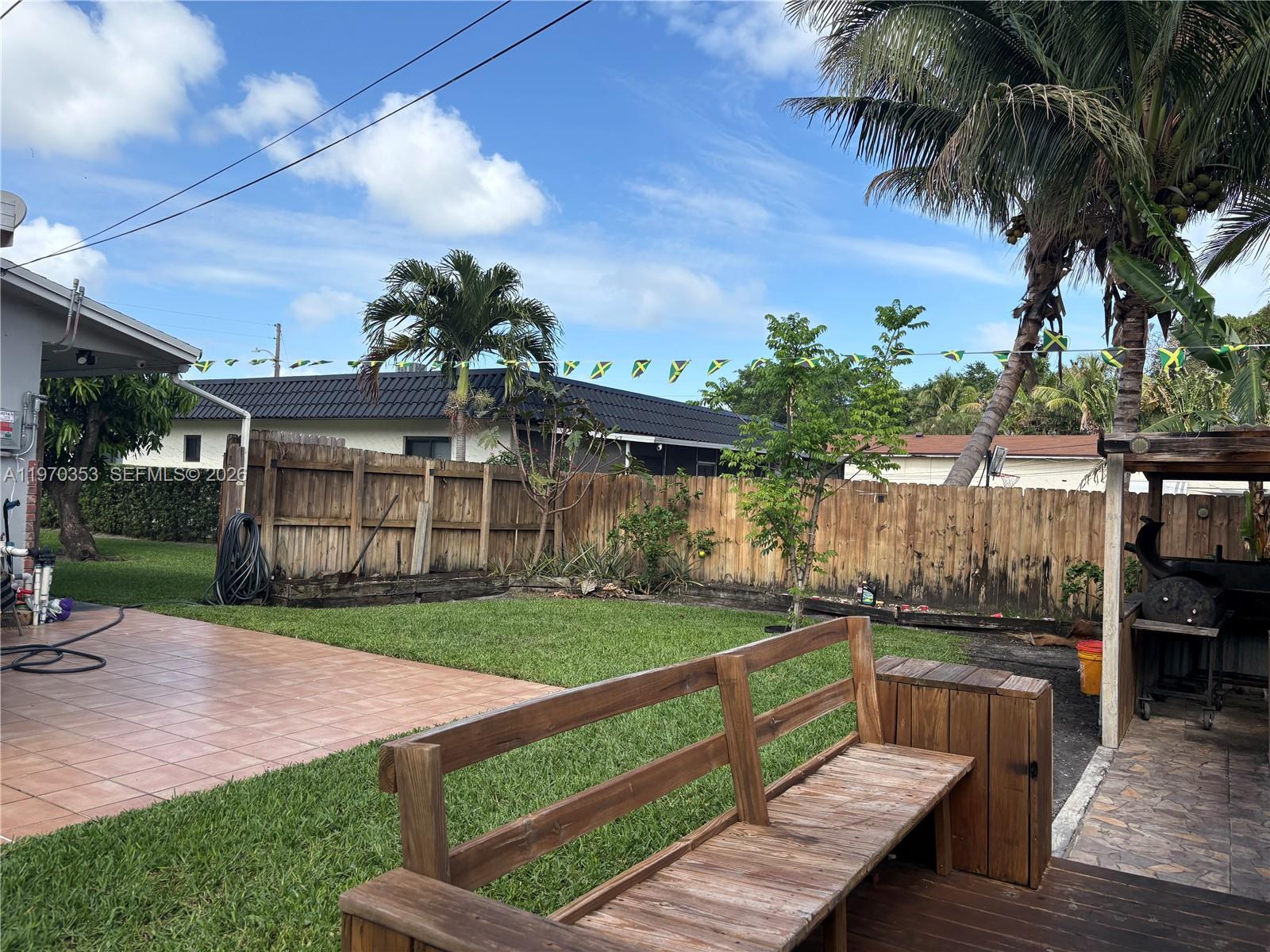 5632 Hayes Street Hollywood, FL 33021 - Photo 29 of 42 a view of a backyard with couches plants and large tree