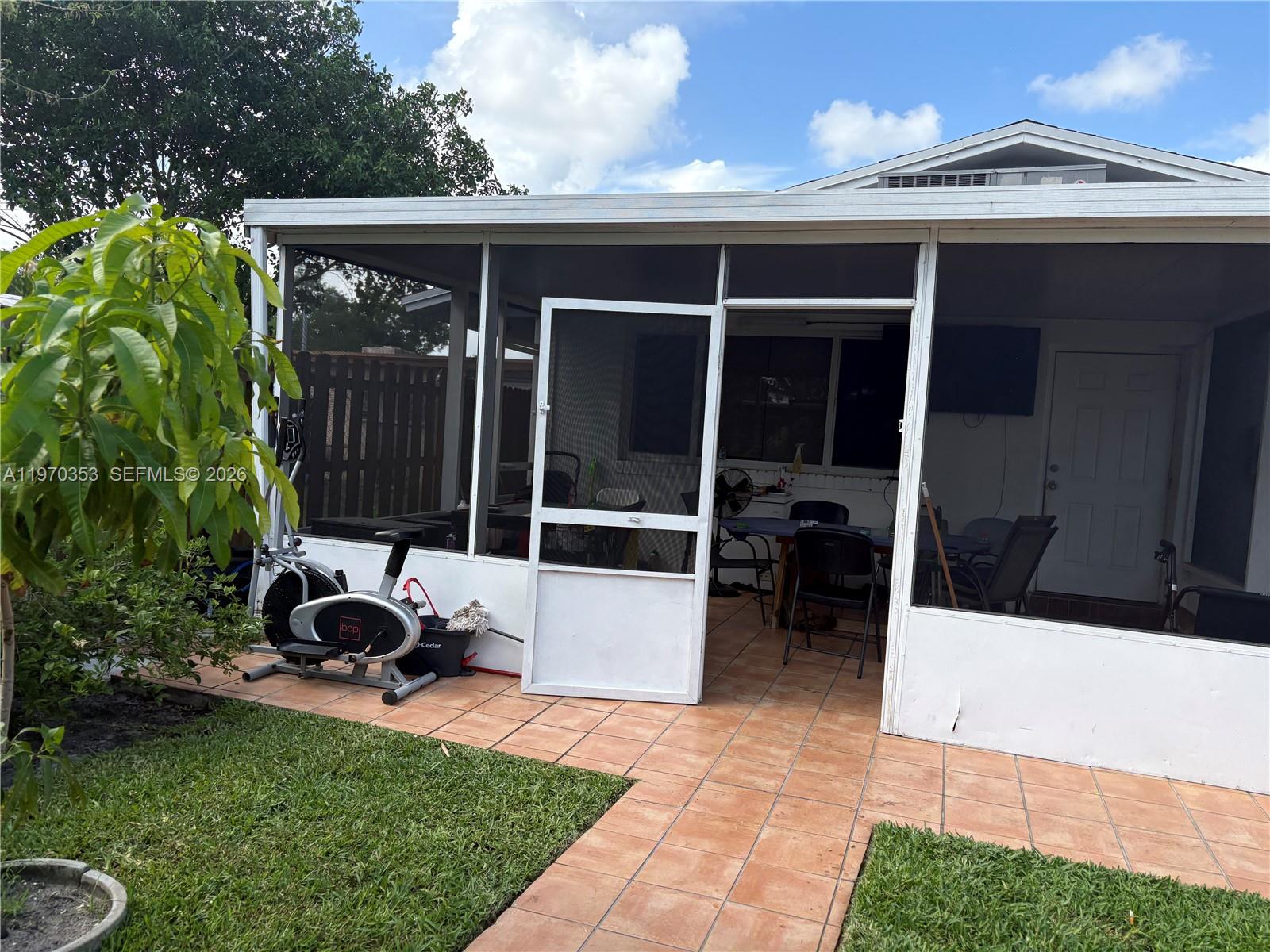 5632 Hayes Street Hollywood, FL 33021 - Photo 30 of 42 a view of a chair and table in backyard of the house