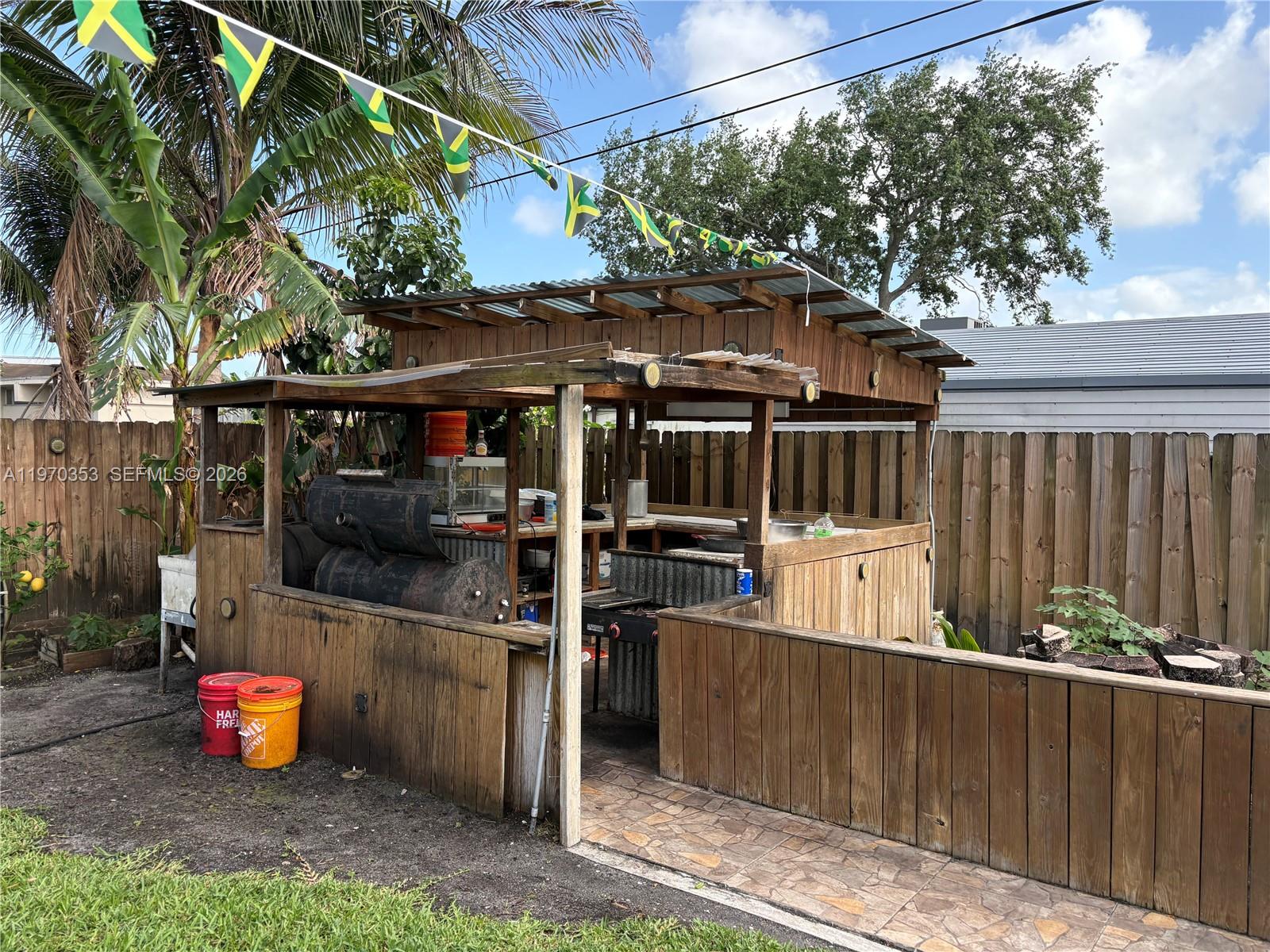 5632 Hayes Street Hollywood, FL 33021 - Photo 34 of 42 a view of a chairs and table in backyard