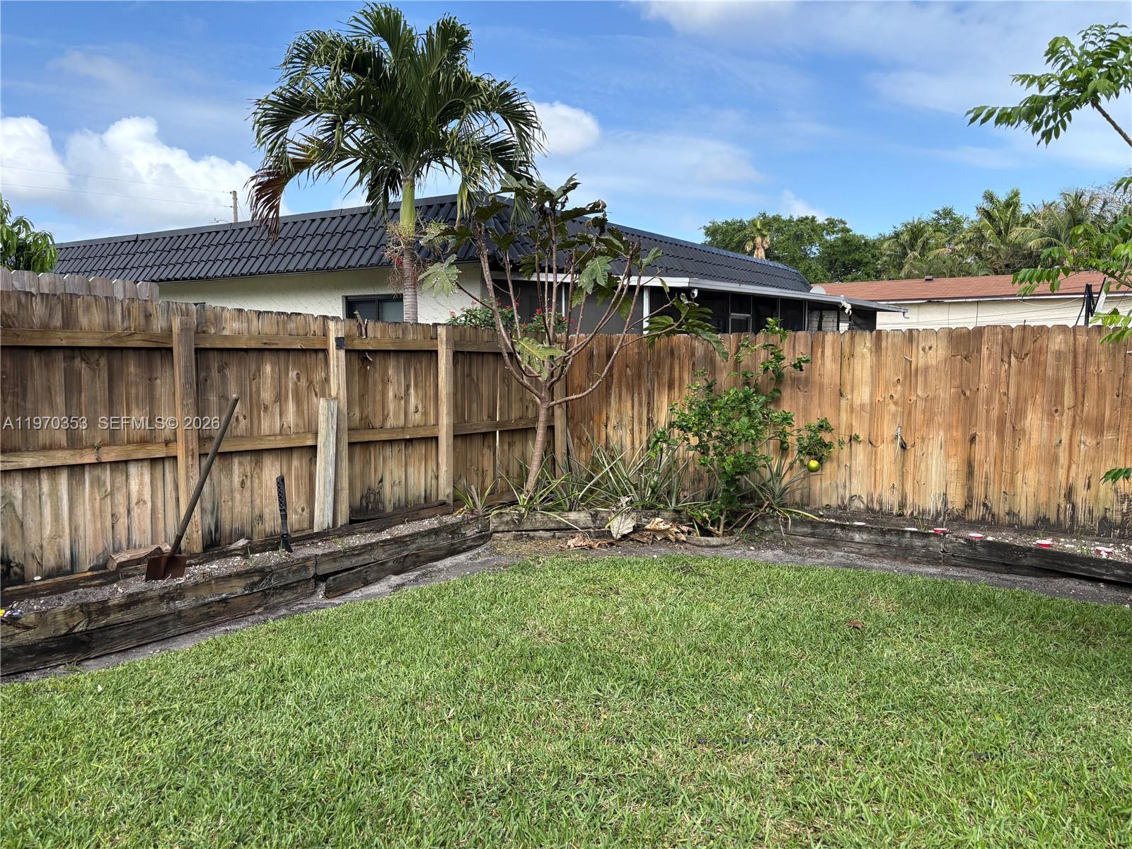 5632 Hayes Street Hollywood, FL 33021 - Photo 36 of 42 a backyard of a house with lots of green space and lake view