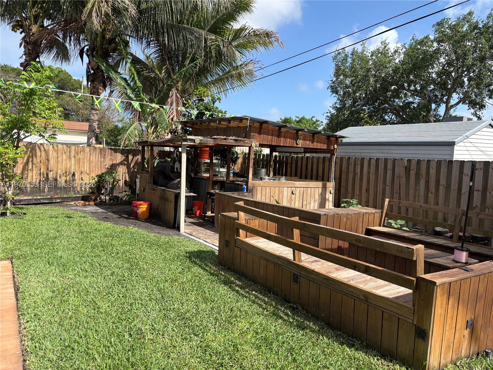 5632 Hayes Street Hollywood, FL 33021 - Photo 38 of 42 a view of a chairs and table in the backyard