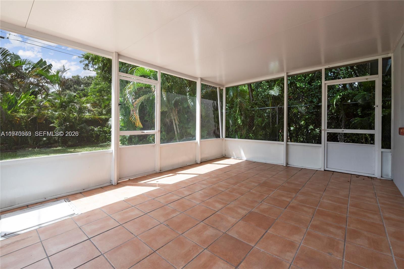 5632 Hayes Street Hollywood, FL 33021 - Photo 6 of 42 a view of an empty room with windows and yard