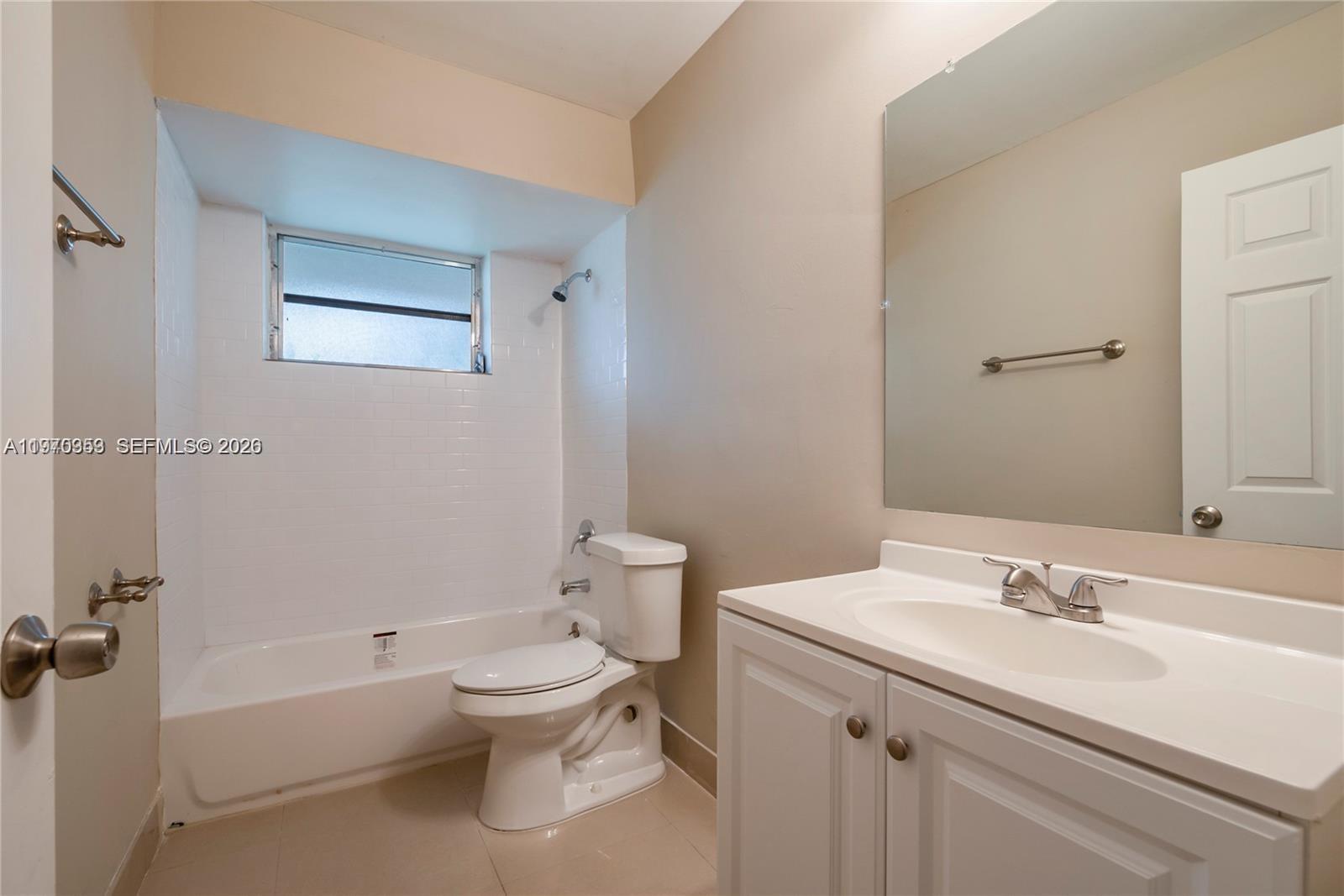 5632 Hayes Street Hollywood, FL 33021 - Photo 9 of 42 a bathroom with a sink toilet and shower