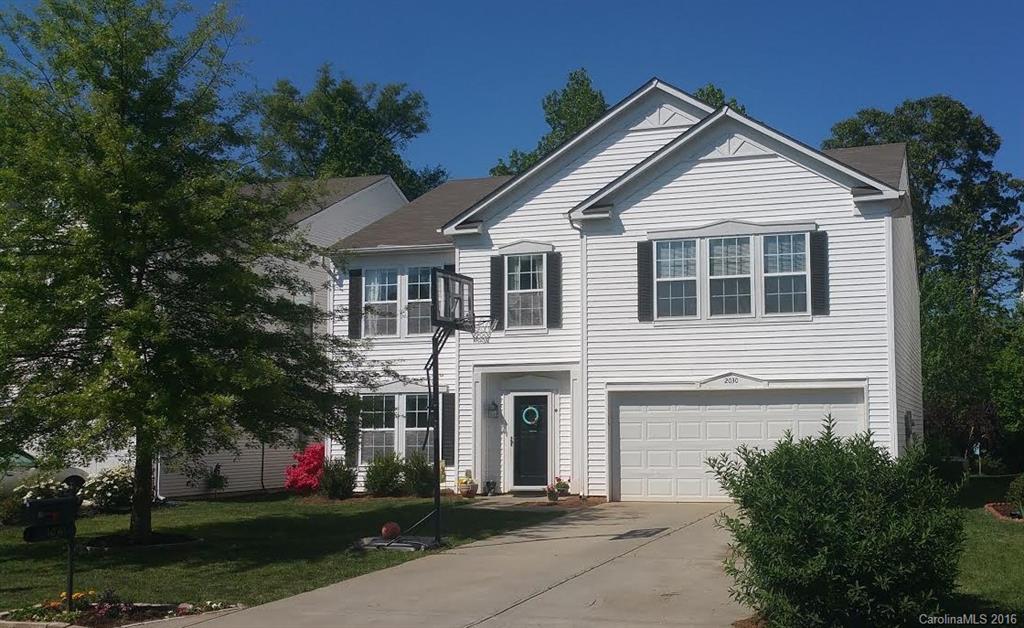 2030 Durand Road, Unit 7 Fort Mill, SC 29715 - Photo 1 of 21 a front view of a house with a garden