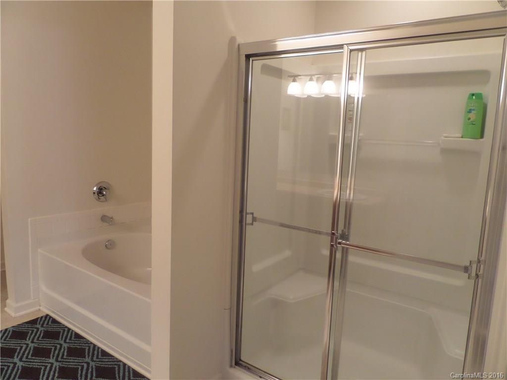 2030 Durand Road, Unit 7 Fort Mill, SC 29715 - Photo 11 of 21 a bathroom with a glass shower door