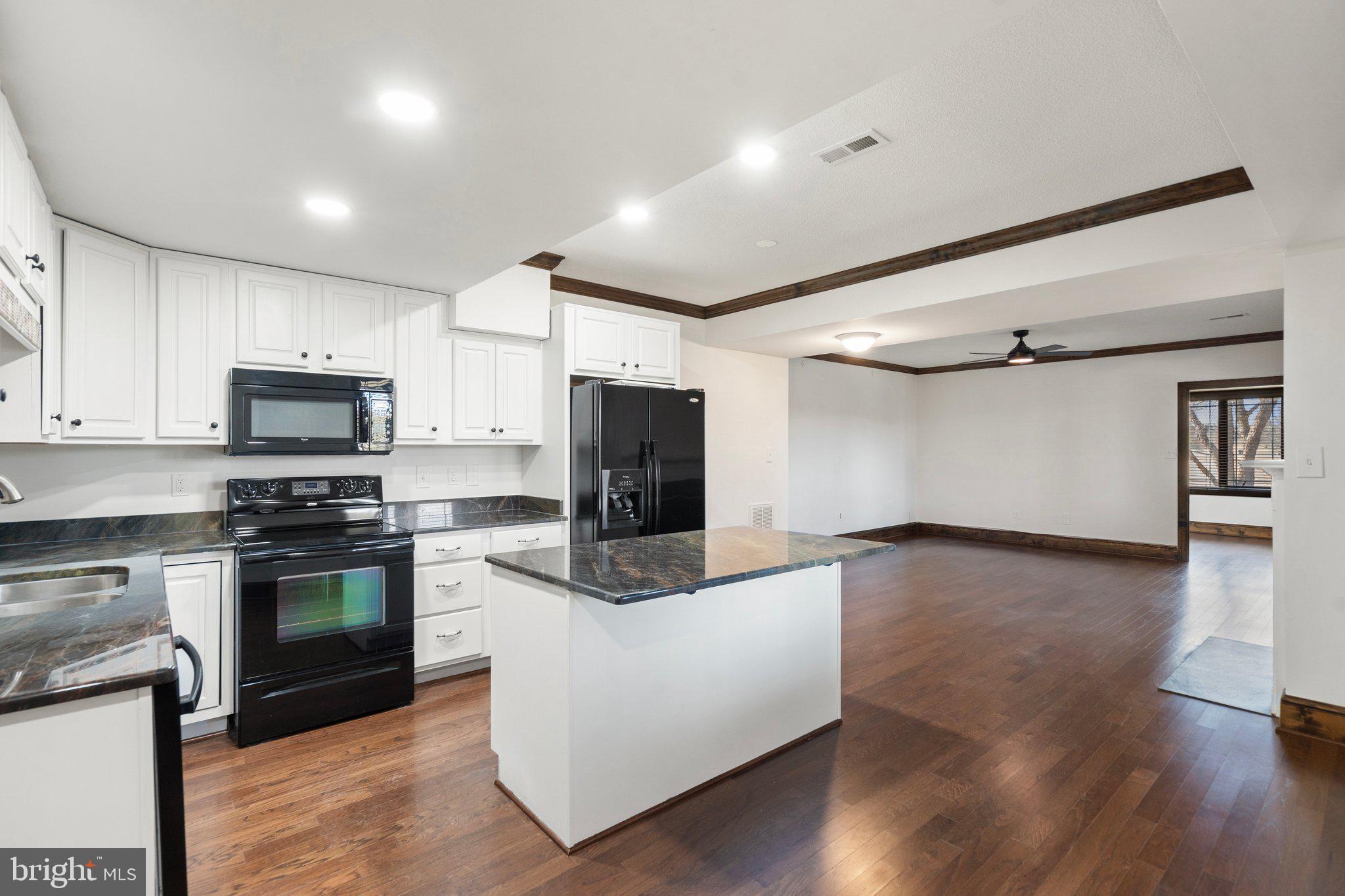 18464 Snaffle Lane Culpeper, VA 22701 - Photo 53 of 64 a kitchen with stainless steel appliances granite countertop a stove top oven a sink and a microwave