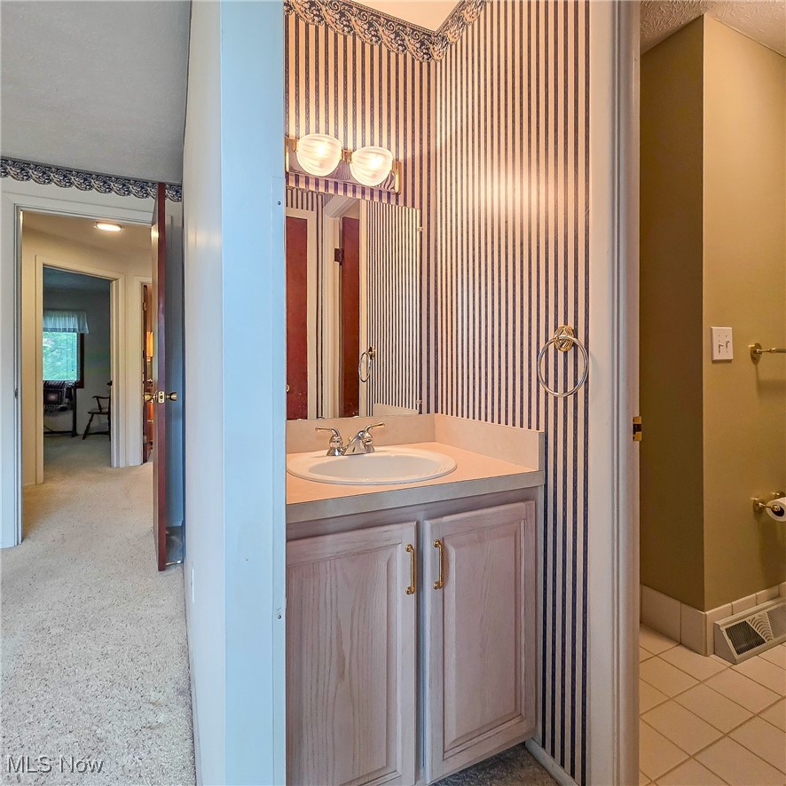 6474 State Road, Unit I10 Parma, OH 44134 - Photo 18 of 31 Bathroom featuring vanity and light tile patterned floors