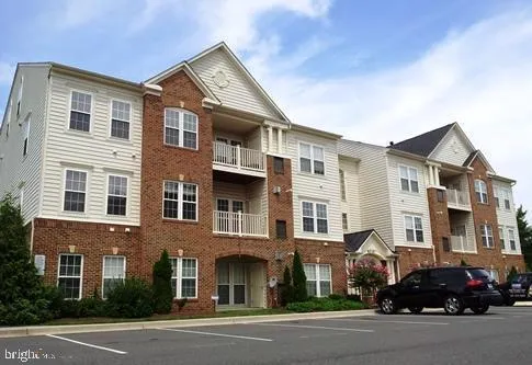 a front view of a residential apartment building with a yard