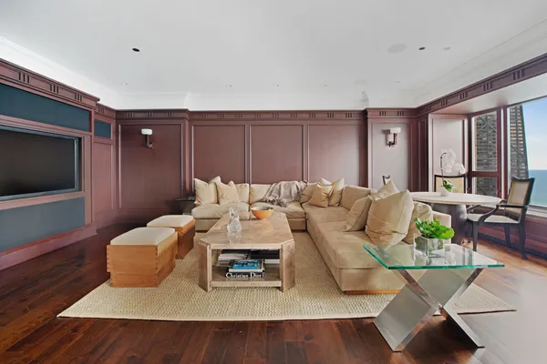 a living room with furniture a fireplace and a large window