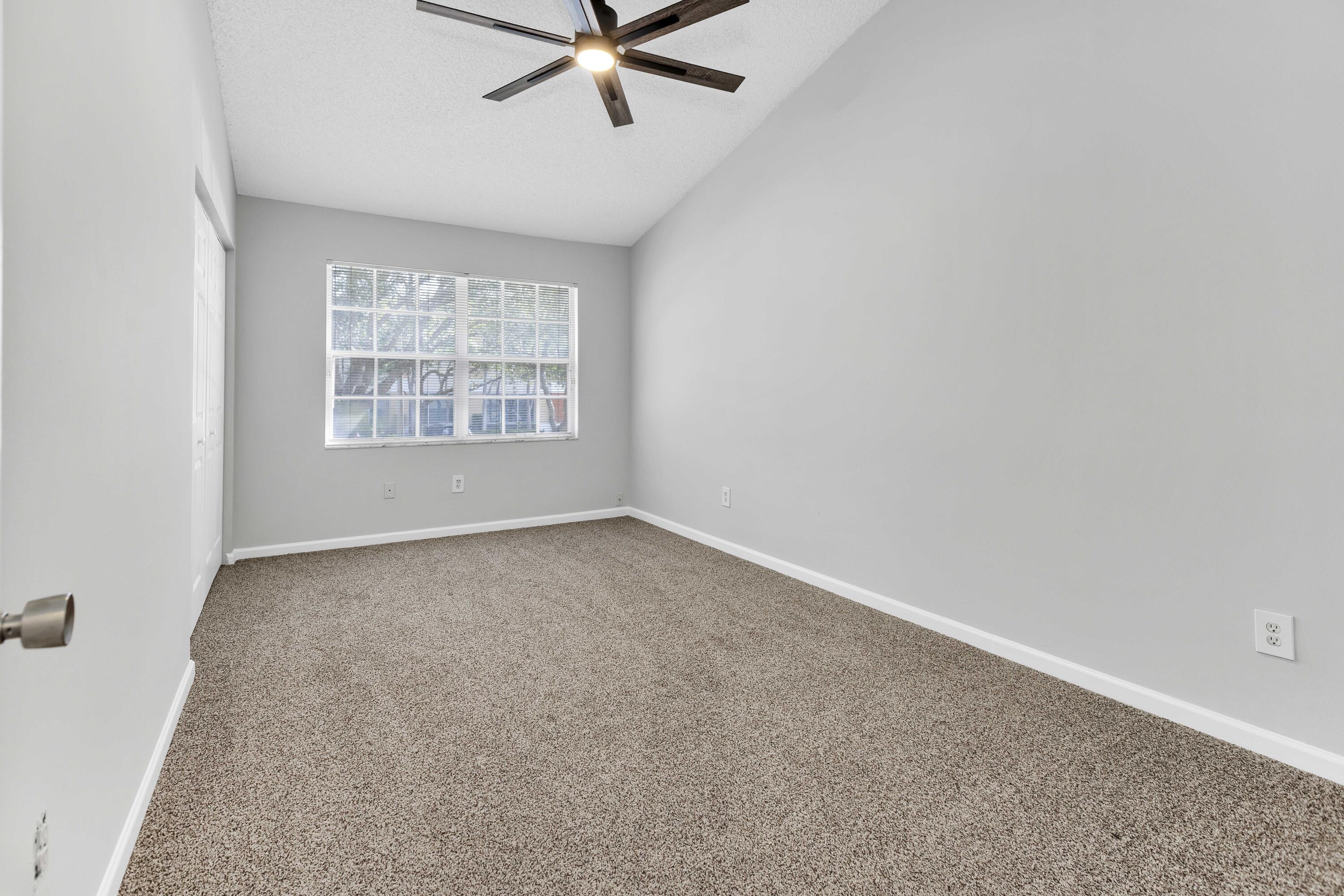 9436 Boca River Circle Boca Raton, FL 33434 - Photo 14 of 20 an empty room with a window and a fan