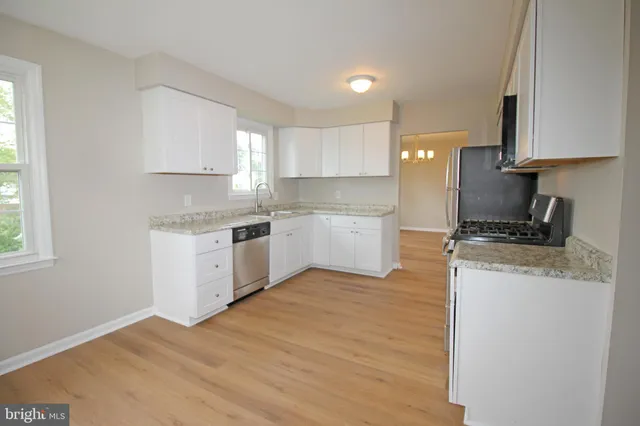 a kitchen with a stove a sink and a refrigerator