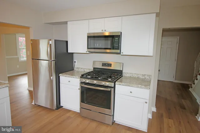 a kitchen with a stove and a microwave