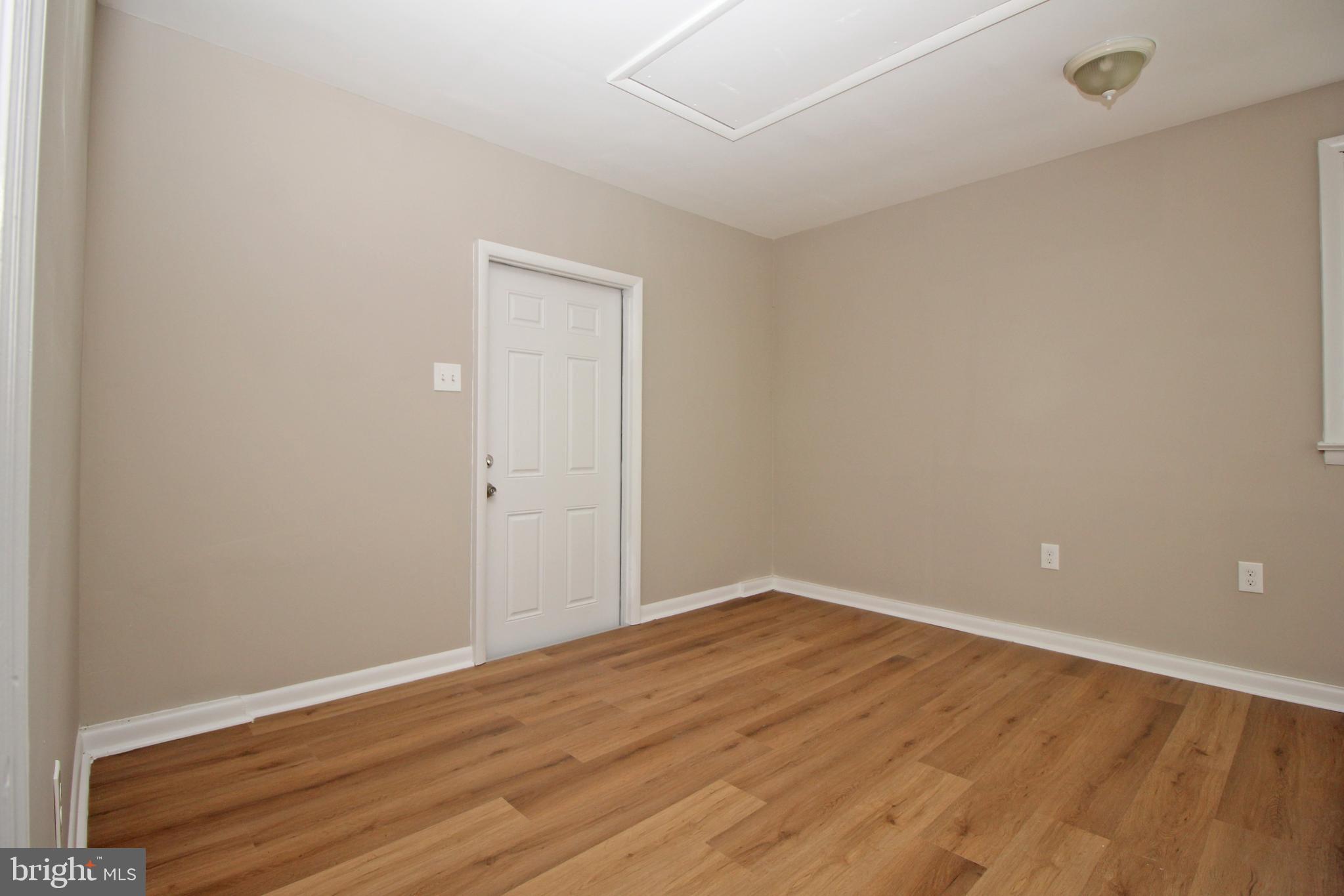 27 West Kennedy Drive Clementon, NJ 08021 - Photo 19 of 39 a view of an empty room with wooden floor