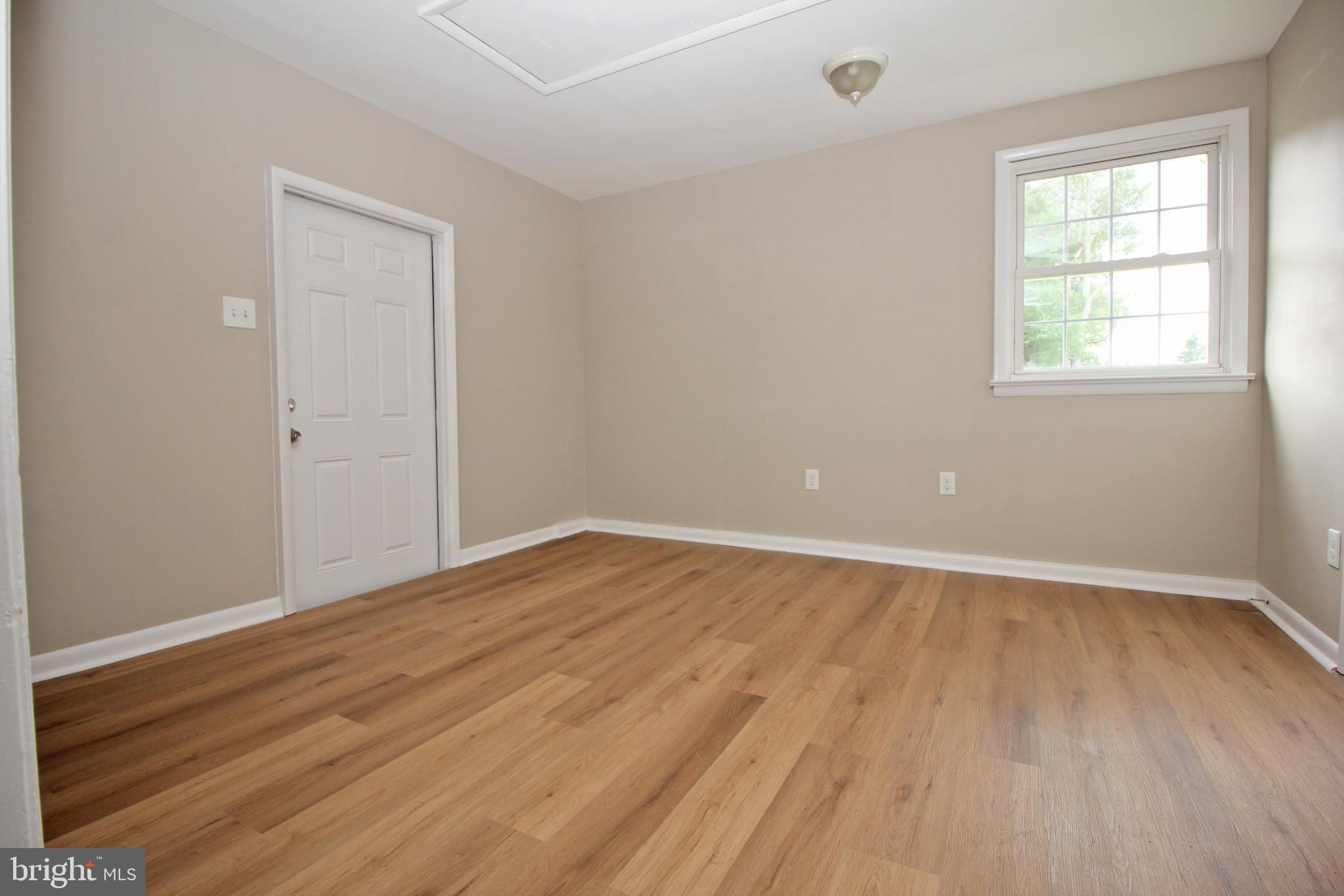 27 West Kennedy Drive Clementon, NJ 08021 - Photo 20 of 39 an empty room with wooden floor and windows