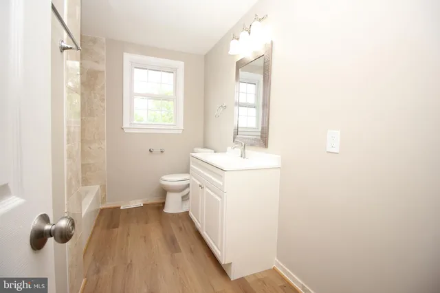 a bathroom with a sink toilet and mirror