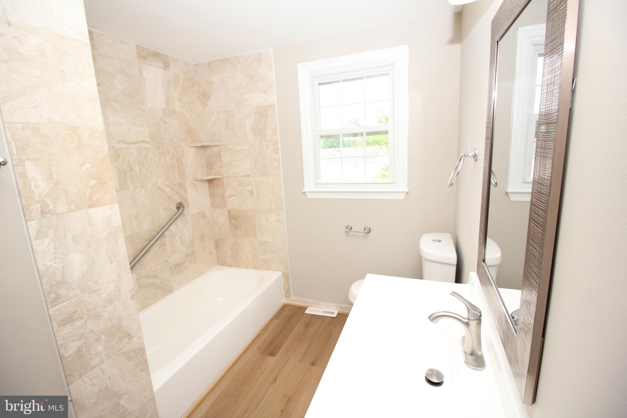 27 West Kennedy Drive Clementon, NJ 08021 - Photo 28 of 39 a bathroom with a tub sink and a mirror