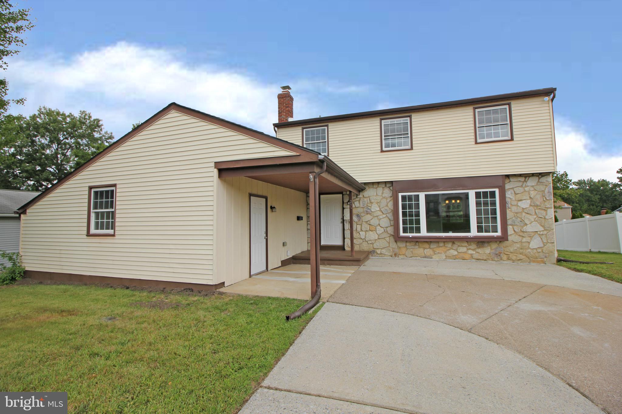27 West Kennedy Drive Clementon, NJ 08021 - Photo 5 of 39 a front view of a house with a garden and yard