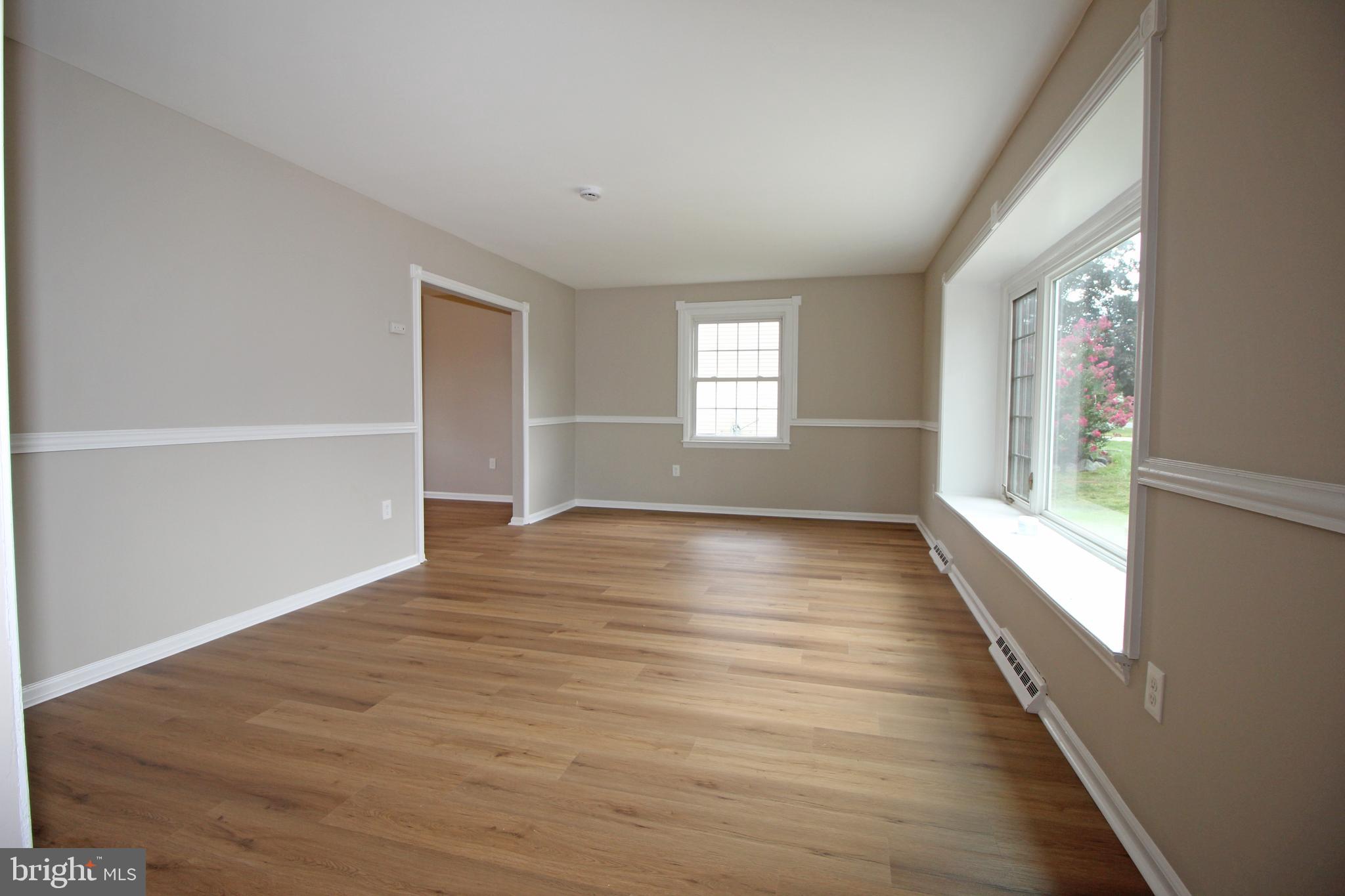 27 West Kennedy Drive Clementon, NJ 08021 - Photo 7 of 39 a view of empty room with wooden floor and fan