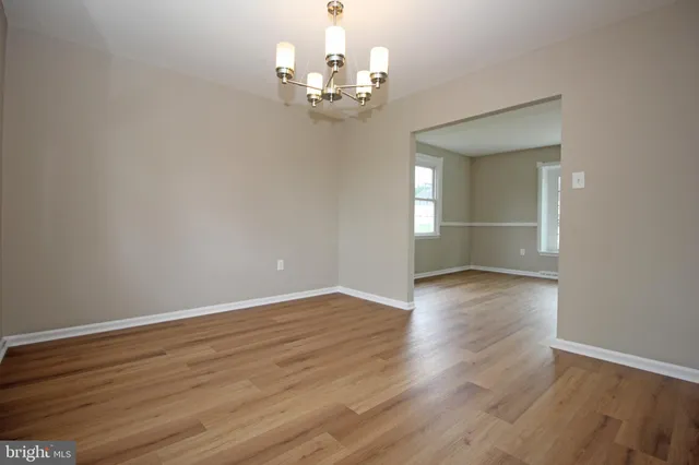a view of a chandelier and wooden floor in a room