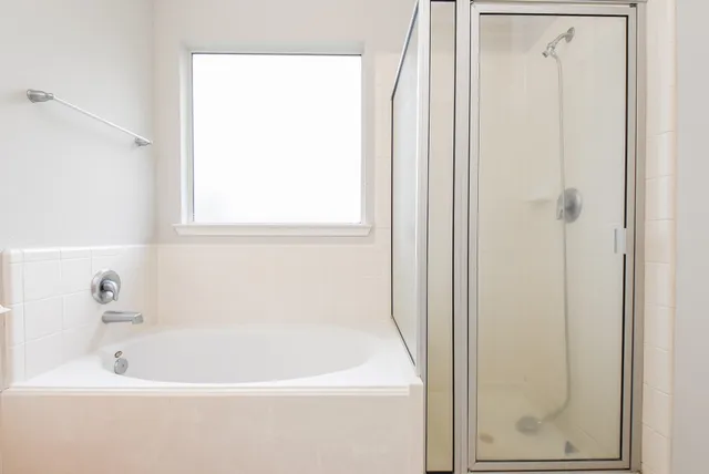 a white bath tub sitting next to a window