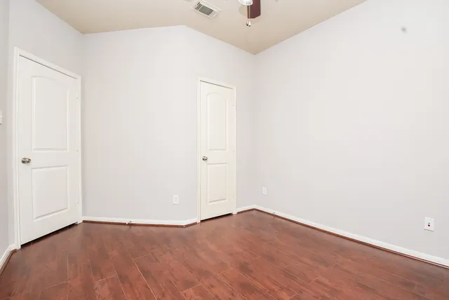 an empty room with wooden floor