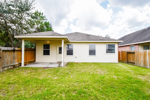 a view of a house with a yard and sitting area